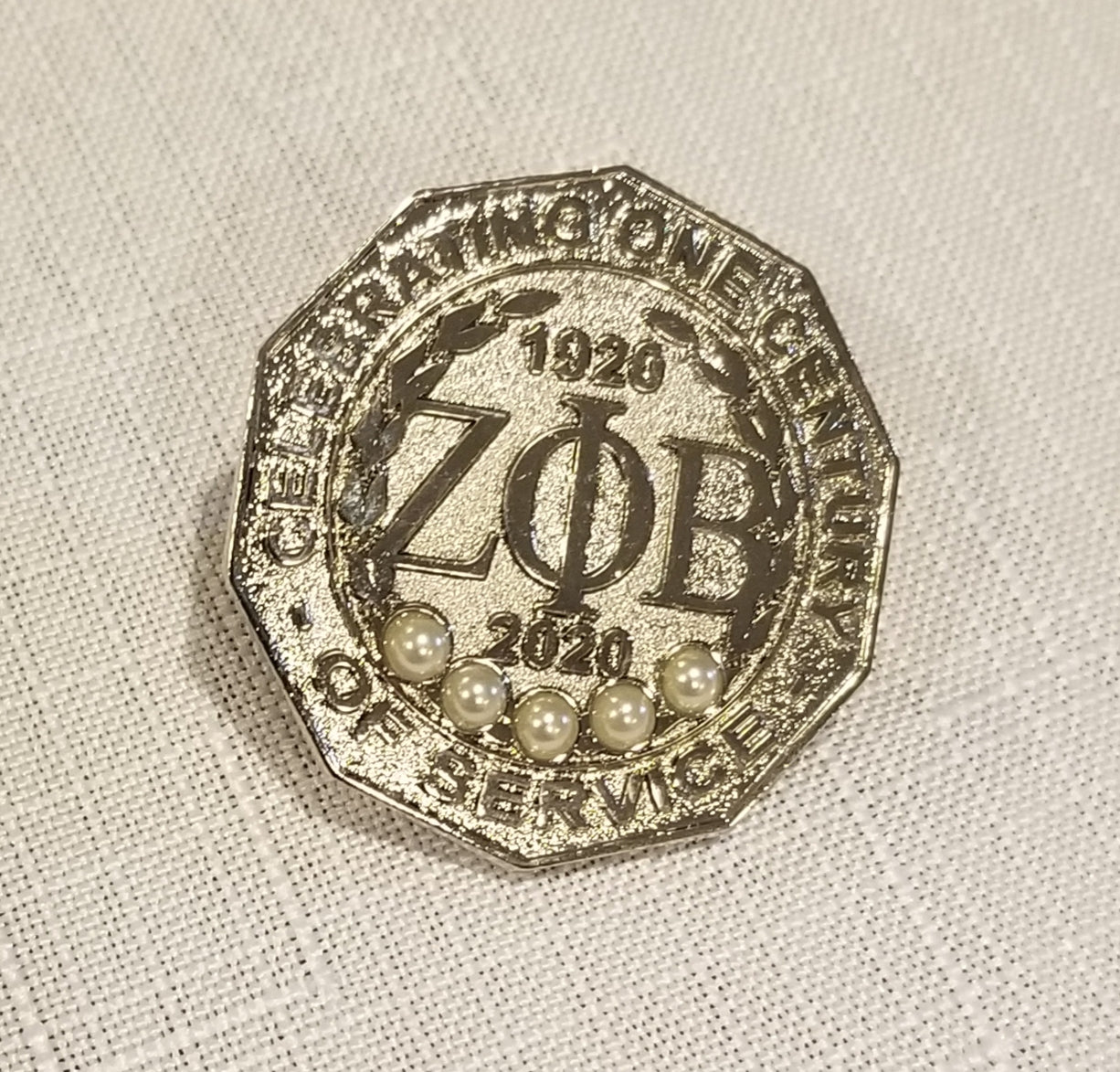 Centennial lapel pin